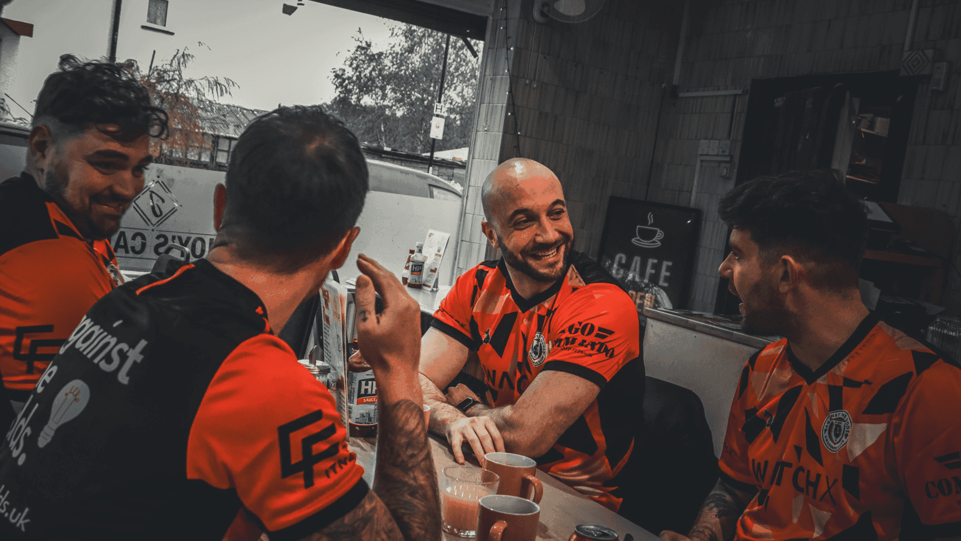 A group of players talking together over a coffee